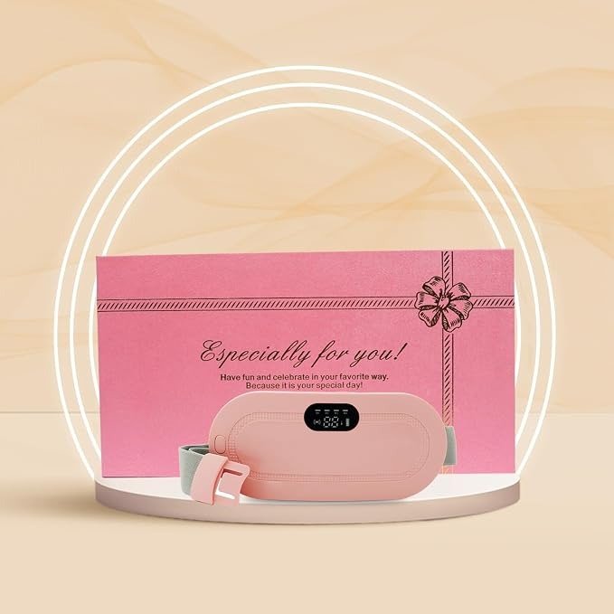 Pink USB rechargeable heating belt for period cramps with digital display, shown in front of a pink gift box